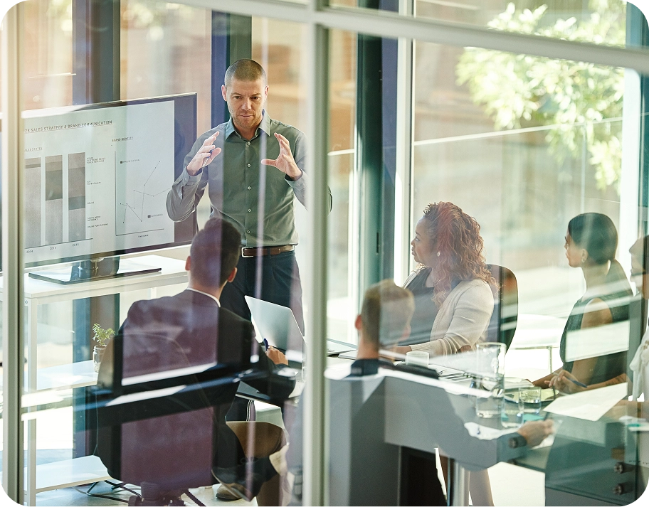 People working in glass meeting room