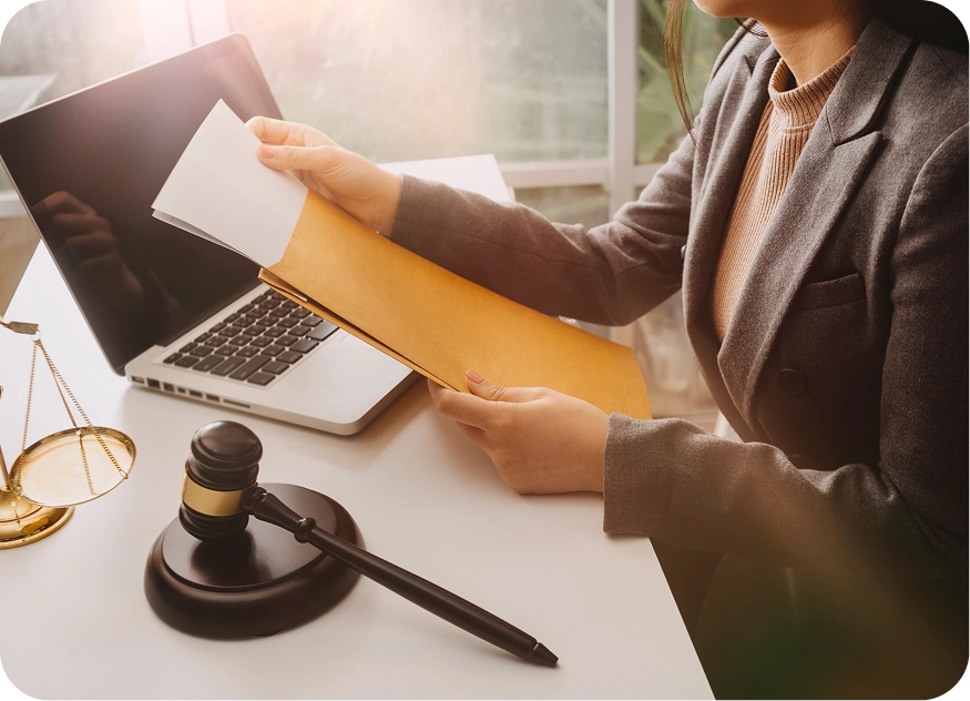 Lawyer opening folder with laptop in background on desk