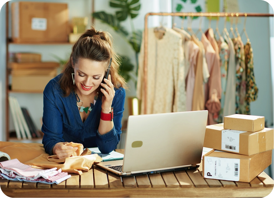 Woman on phone and laptop working for small business
