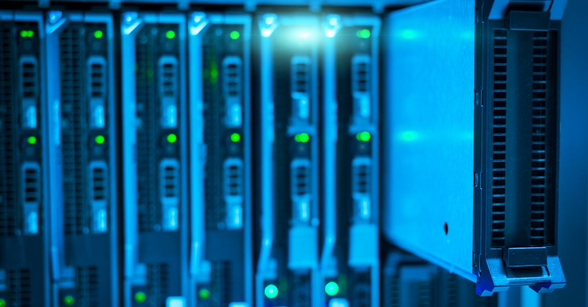 IT technician checking a network security appliance in a server rack
