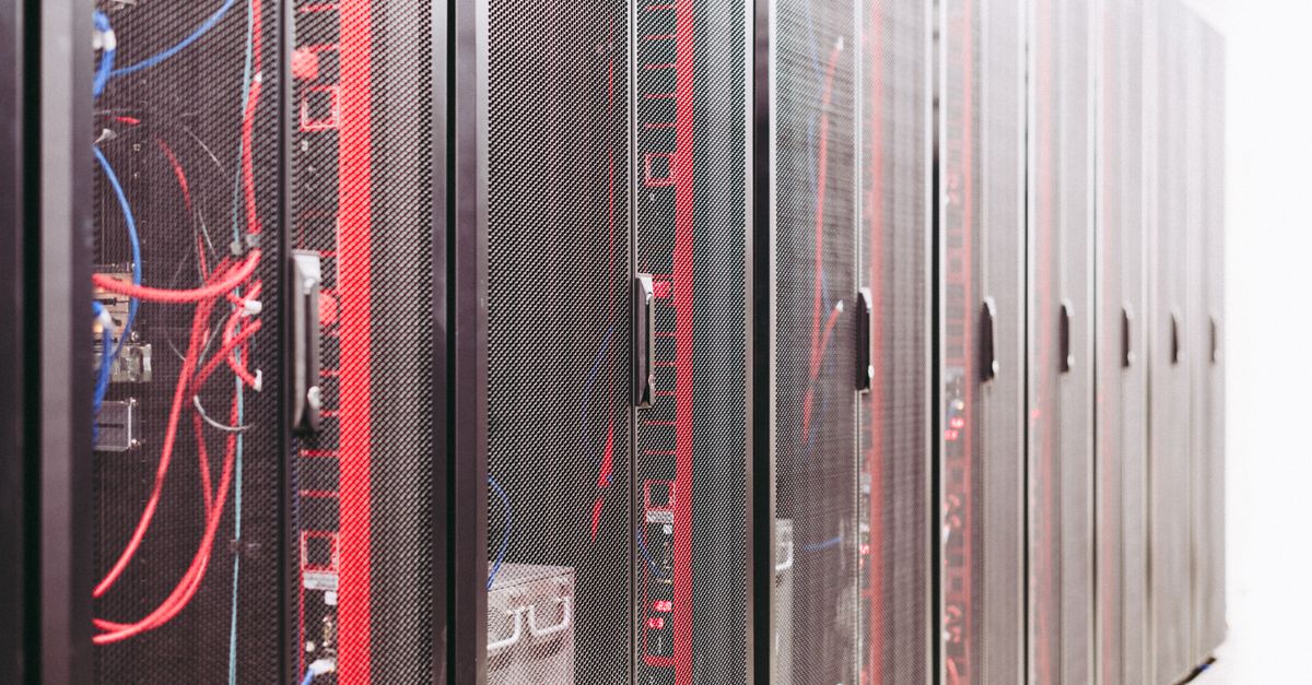 IT technician checking server hardware in a data center, representing Windows Server 2022 reaching end of mainstream support